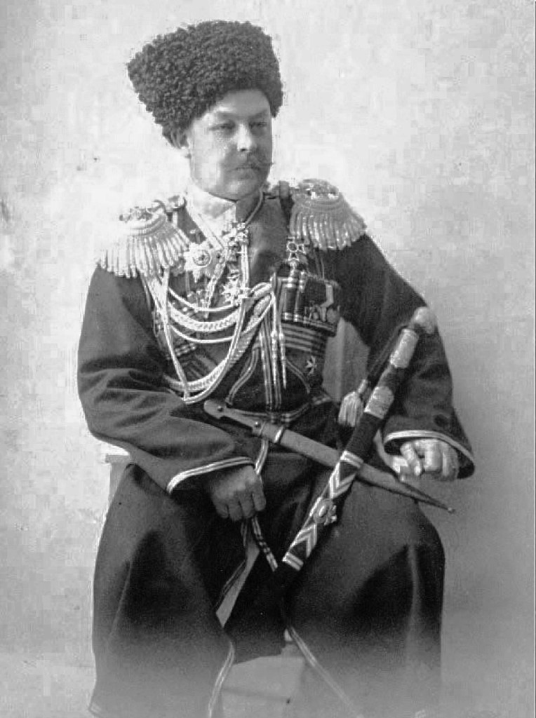 A historical portrait of a man in elaborate military uniform, adorned with various medals and decorations, seated with a sword and a ceremonial dagger, wearing a traditional fur hat.