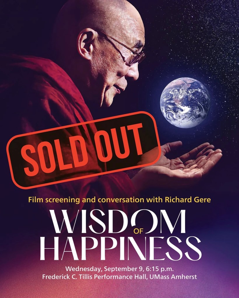 Promotional poster for the 'Wisdom of Happiness' event featuring a profile of the Dalai Lama, with the Earth represented in the background. A 'SOLD OUT' stamp is overlaid. Event details include a film screening and conversation with Richard Gere on September 9 at 6:15 p.m. at Frederick C. Tillis Performance Hall, UMass Amherst.